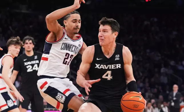 FILE - Xavier's Filip Borovicanin, right, drives on UConn's Jayden Ross (23) during second half of an NCAA college basketball game in the quarterfinals of the Big East basketball tournament Thursday, March 12, 2026, in New York. (AP Photo/Frank Franklin II, File)