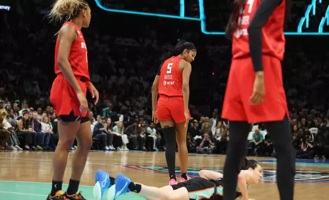 Atlanta Dream forward Angel Reese (5) reacts after forcing a jump ball with New York Liberty forward Breanna Stewart, bottom during the first half of Game 3 of the WNBA basketball semifinals, Friday, Oct. 9, 2026, in New York. (AP Photo/Heather Khalifa)