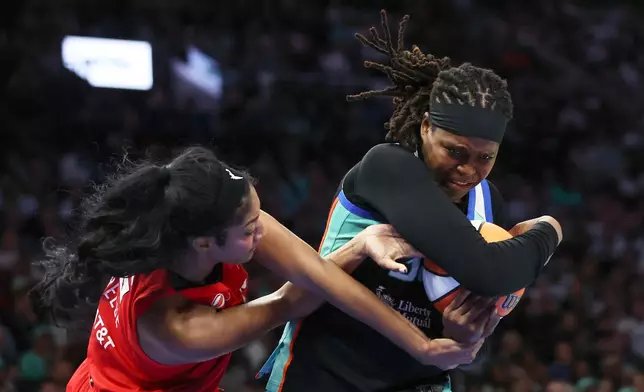 New York Liberty center Jonquel Jones, right, keeps the ball away from Atlanta Dream forward Angel Reese, left, during the second half of Game 3 of the WNBA basketball semifinals, Friday, Oct. 9, 2026, in New York. (AP Photo/Heather Khalifa)