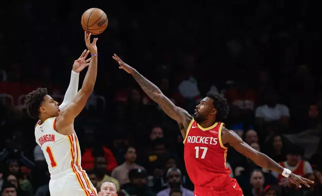 Atlanta Hawks forward Jalen Johnson (1) shoots against Houston Rockets forward Tari Eason (17) during the first half of an NBA basketball game, Saturday, Oct. 24, 2026, in Atlanta. (AP Photo/Erik S. Lesser)