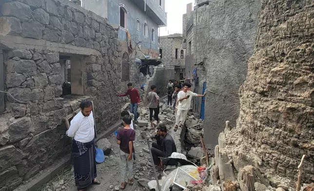 Residents inspect debris of their homes after a missile strike in Seina, Taiz, Yemen, Tuesday, Oct. 20, 2026. (AP Photo/Marzouq Al Jabri)