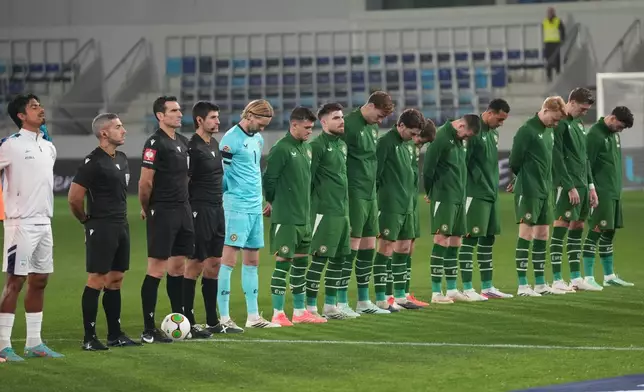 Irish players bow their heads during Israeli national anthem before the UEFA Nations League soccer match between the Republic of Ireland and Israel in Backa Topola, Serbia, Sunday, Oct. 4, 2026. (AP Photo/Darko Vojinovic)