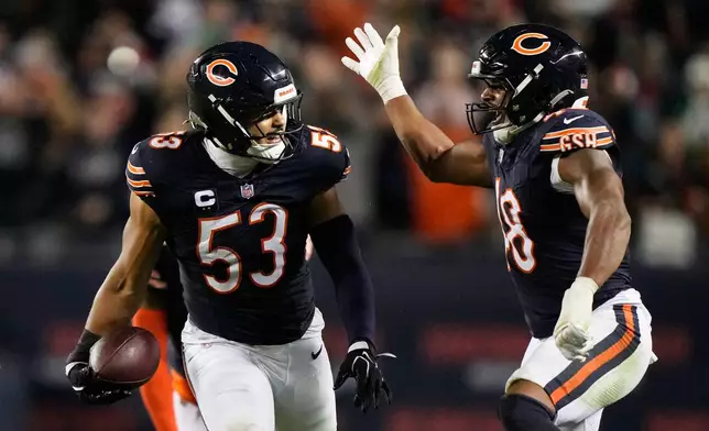 Chicago Bears linebacker T.J. Edwards (53) and linebacker D'Marco Jackson, right, celebrate after Edwards intercepted a pass during the second half of an NFL football game against the Philadelphia Eagles in Chicago, Monday, Sept. 28, 2026. (AP Photo/Nam Y. Huh)