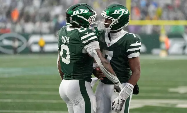 New York Jets running back Braelon Allen (0) celebrates with teammate quarterback Geno Smith (7) after a touchdown run during the second half of an NFL football game against the Cleveland Browns, Sunday, Oct. 11, 2026, in East Rutherford, N.J. (AP Photo/Seth Wenig)