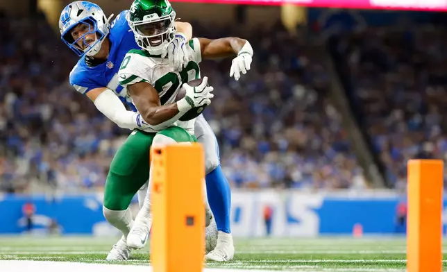 Detroit Lions' Trevor Nowaske stops New York Jets' Breece Hall during the second half of an NFL football game in Detroit, Sunday, Sept. 27, 2026. (AP Photo/Rey Del Rio)