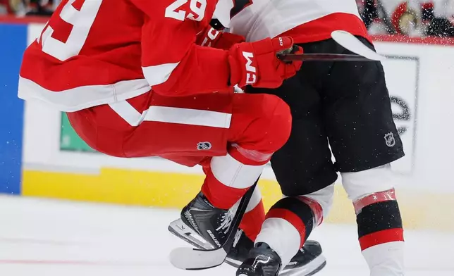 Detroit Red Wings center Nate Danielson (29) collides with Ottawa Senators center Tim Stutzle (18) while bringing the puck up the ice during the second period of an NHL hockey game Tuesday, Oct. 6, 2026, in Detroit. (AP Photo/Duane Burleson)