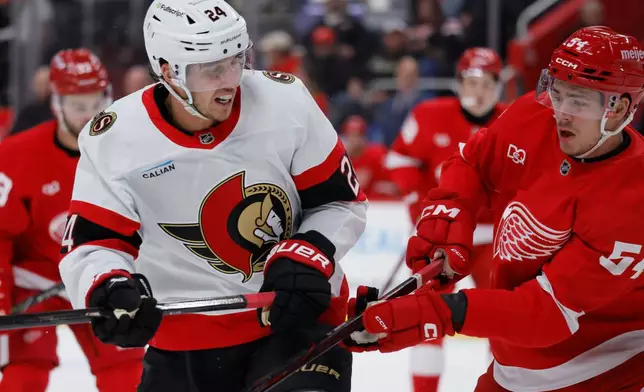 Ottawa Senators center Dylan Cozens (24) is goes up against Detroit Red Wings defenseman William Wallinder (54) during the first period of an NHL hockey game Tuesday, Oct. 6, 2026, in Detroit. (AP Photo/Duane Burleson)