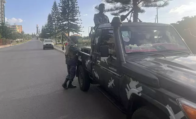 In this photo taken with a smartphone, Ethiopian federal police officers gather on a road in Mekelle, Tigray Region, Ethiopia, Thursday, Oct. 8, 2026. (AP Photo/Filmon Equar Hailu)