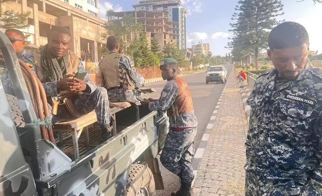 In this photo taken with a smartphone, Ethiopian federal police officers gather on a road in Mekelle, Tigray Region, Ethiopia, Thursday, Oct. 8, 2026. (AP Photo/Filmon Equar Hailu)