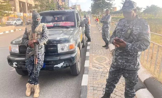 In this photo taken with a smartphone, Ethiopian federal police officers gather on a road in Mekelle, Tigray Region, Ethiopia, Thursday, Oct. 8, 2026. (AP Photo/Filmon Equar Hailu)