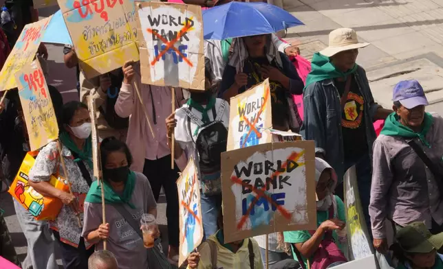 Protesters march to a meeting venue during a demonstration against the International Monetary Fund and the World Bank Group in Bangkok, Thailand, Friday, Oct. 16, 2026. (AP Photo/Sakchai Lalit)