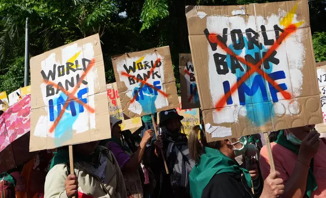 Protesters march to a meeting venue during a demonstration against the International Monetary Fund and the World Bank Group in Bangkok, Thailand, Friday, Oct. 16, 2026. (AP Photo/Sakchai Lalit)