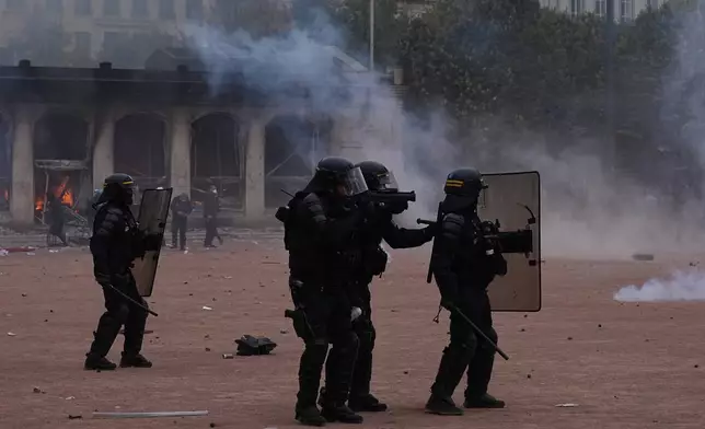 Riot police face protesters during a demonstration against rising living costs and in support of students’ grievances in Paris, Saturday, Oct. 17, 2026. (AP Photo/Laurent Cipriani)