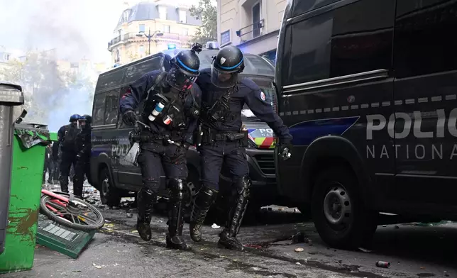 Police officers leave the Republique square during a demonstration against rising living costs, joining students' grievances, in Paris, Saturday, Oct. 17, 2026. (AP Photo/Emma Da Silva)