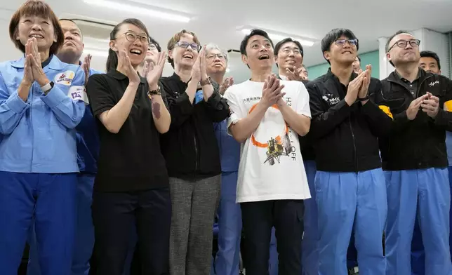 Employees of Japan Aerospace Exploration Agency and others celebrate as a Japanese spacecraft launched aboard an H3 rocket successfully separated as planned, at the Tanegashima Space Center in Kagoshima prefecture, southern Japan, Tuesday Oct. 20, 2026. (Naoki Hiraoka/Kyodo News via AP)