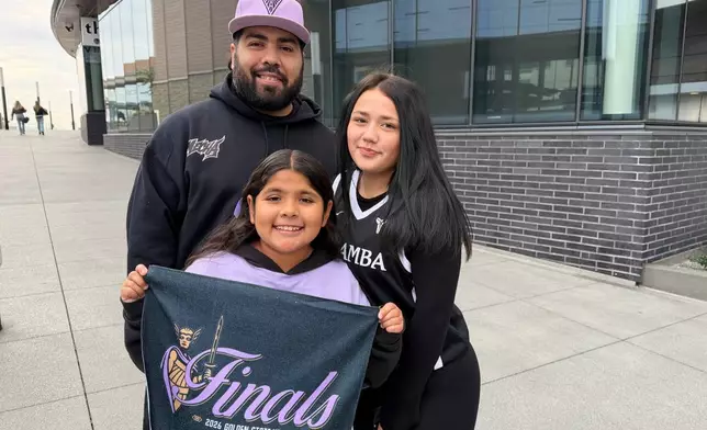 Joshua Padilla and daughters Malia, 10, and Mariah, 15, came from Santa Clara to attend the Golden State Valkyries’ watch party at Chase Center’s Thrive City plaza, Thursday morning, Oct. 29, 2026, in San Francisco, to watch a broadcast of Game 6 of the WNBA basketball finals against the Atlanta Dream. (AP Photo/Janie McCauley) Photo taken with a smartphone.
