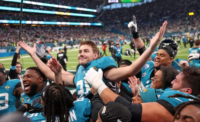 Jacksonville Jaguars place kicker Cam Little (39) celebrates after scoring the winning field goal during an NFL football game against Philadelphia Eagles in London, Sunday, Oct. 11, 2026. (AP Photo/Ian Walton)
