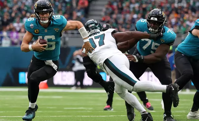 Jacksonville Jaguars quarterback Trevor Lawrence (16) runs with the ball during an NFL football game against Philadelphia Eagles in London, Sunday, Oct. 11, 2026. (AP Photo/Ian Walton)