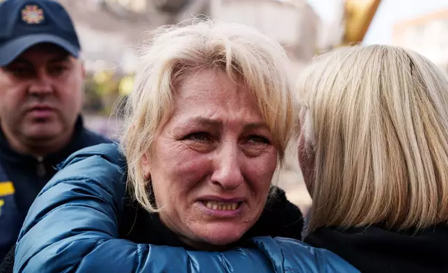 A woman reacts standing next to a residential building destroyed in a Russian missile strike on Pryluky, Ukraine, Wednesday, Oct. 7, 2026. (AP Photo/Evgeniy Maloletka)