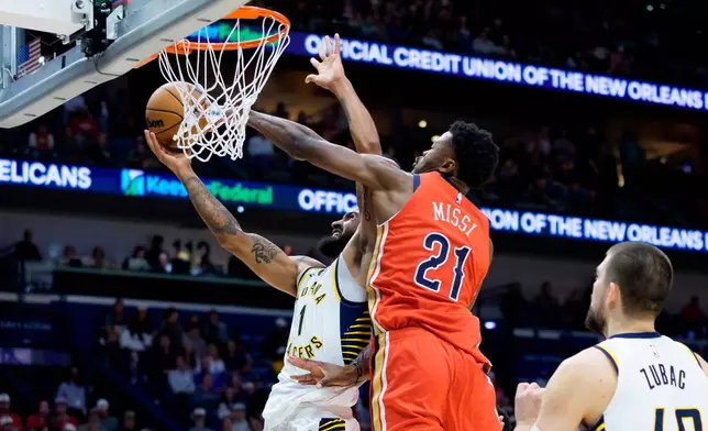 New Orleans Pelicans center Yves Missi (21) defends against Indiana Pacers forward Obi Toppin (1) during the first half of an NBA basketball game in New Orleans, Wednesday, Oct. 21, 2026. (AP Photo/Matthew Hinton)