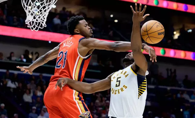 New Orleans Pelicans center Yves Missi (21) blocks the shot of Indiana Pacers forward Jarace Walker (5) during the first half of an NBA basketball game in New Orleans, Wednesday, Oct. 21, 2026. (AP Photo/Matthew Hinton)
