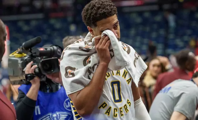 Indiana Pacers guard Tyrese Haliburton (0) wipes his eye at the end of an NBA basketball game against the New Orleans Pelicans in New Orleans, Wednesday, Oct. 21, 2026. (AP Photo/Matthew Hinton)
