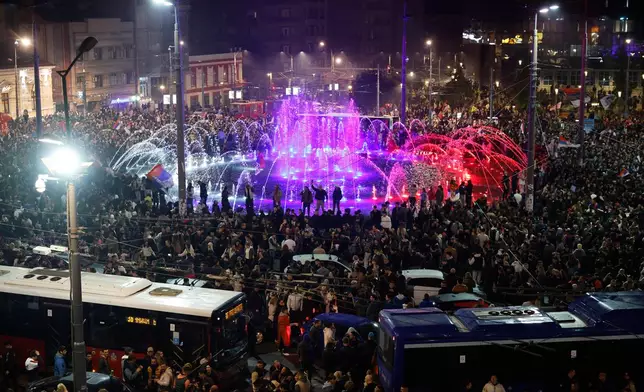 People celebrate after Aleksandar Vucic, leader of the right-wing Serbian Progressive Party (SNS) conceded defeat in the parliamentary election in Belgrade, Serbia, Sunday, Oct. 25, 2026. (AP Photo/Marko Drobnjakovic)