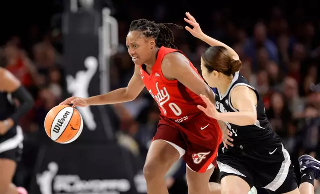 Indiana Fever guard Kelsey Mitchell (0) drives against Las Vegas Aces guard Mai Yamamoto (18) during the first half in Game 3 of an WNBA basketball first-round playoff series Thursday, Oct.1, 2026, in Las Vegas. (AP Photo/Steve Marcus)