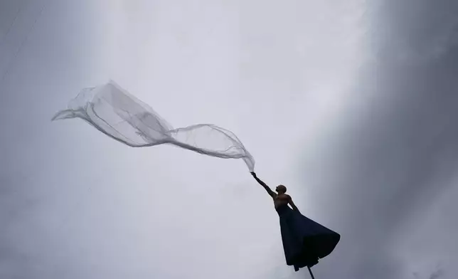 A performer from the French company Gratte Ciel presents the open-air aerial circus show “RoZéo” as part of the Festival CulturaUNAM program in Mexico City, Saturday, Oct. 10, 2026. (AP Photo/Eduardo Verdugo)