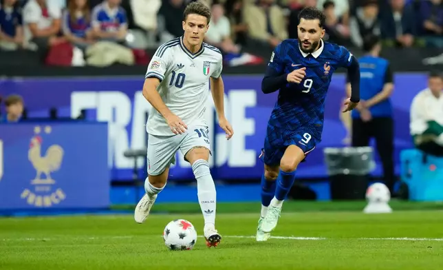 France's Rayan Cherki, right, and Italy's Nicolo Fagioli challenge for the ball during the UEFA Nations League Group A soccer match between France and Italy in Saint-Denis near Paris, Friday, Oct. 2, 2026. (AP Photo/Teresa Suarez)