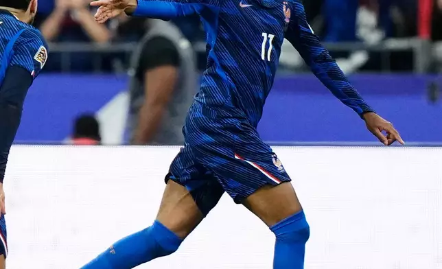 France's Michael Olise celebrates after scoring the opening goal during the UEFA Nations League Group A soccer match between France and Italy in Saint-Denis near Paris, Friday, Oct. 2, 2026. (AP Photo/Teresa Suarez)