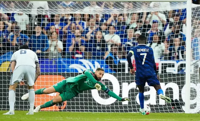 Italy's goalkeeper Gianluigi Donnarumma makes a save of a shoot by France's Ousmane Dembele, right, during the UEFA Nations League Group A soccer match between France and Italy in Saint-Denis near Paris, Friday, Oct. 2, 2026. (AP Photo/Teresa Suarez)