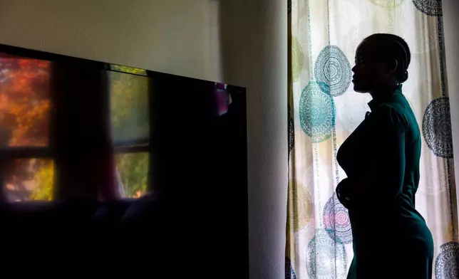FILE - A Congolese refugee, a plaintiff in a federal lawsuit over the Trump administration's move to shut down the "join-to-follow" refugee program, poses at her home in Boise, Idaho, June 23, 2025. (AP Photo/Kyle Green, file)