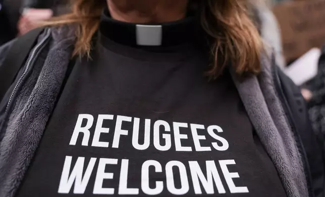 FILE - Pastor Jennifer Castle joins others outside the U.S. District Court after a federal judge blocked President Donald Trump's effort to halt the nation's refugee admissions system, Feb. 25, 2025, in Seattle. (AP Photo/Ryan Sun, file)