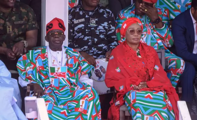 President Bola Tinubu, with the All Progressives Congress Party, left, and his wife, Oluremi Tinubu, attend the first election campaign of the season in Kaduna, Nigeria, Saturday, Oct. 24, 2026. (AP Photo/Sani Maikatanga)