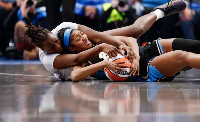 Golden State Valkyries center Aminata Gueye, left, and Atlanta Dream forward Angel Reese (5) compete for possession of the ball during the second half of Game 3 of the WNBA basketball finals on Wednesday, Oct. 21, 2026, in Atlanta. (Santiago Mejia/San Francisco Chronicle via AP)