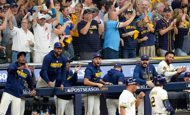 Milwaukee Brewers players and fans cheer during the eighth inning of Game 2 of baseball's National League Championship Series between the Milwaukee Brewers and the Los Angeles Dodgers, Monday, Oct. 12, 2026, in Milwaukee. (AP Photo/Kayla Wolf)