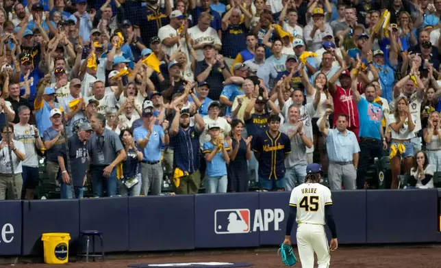Milwaukee Brewers pitcher Abner Uribe leaves the game during the eighth inning of Game 2 of baseball's National League Championship Series between the Milwaukee Brewers and the Los Angeles Dodgers, Monday, Oct. 12, 2026, in Milwaukee. (AP Photo/Kayla Wolf)