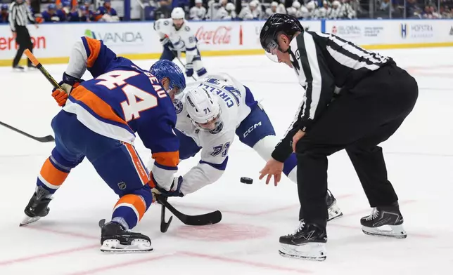 New York Islanders' Jean-Gabriel Pageau (44) and Tampa Bay Lightning's Anthony Cirelli (71) face off during the first period of an NHL hockey game, Saturday, Oct. 10, 2026, in Elmont, N.Y. (AP Photo/Pamela Smith)