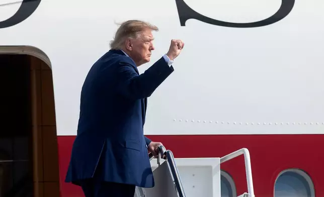President Donald Trump gestures as he boards Air Force One at Joint Base Andrews, Md., Friday, Oct. 16, 2026. (AP Photo/Cliff Owen)