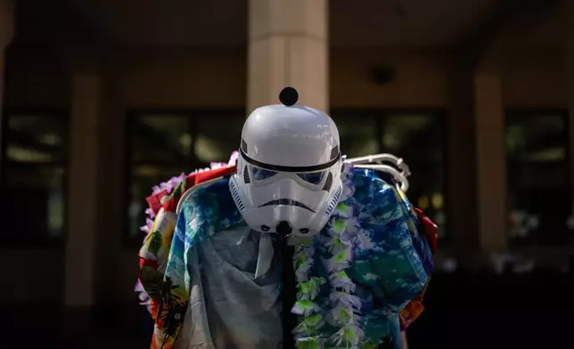A stormtrooper mask is displayed with Hawaiian shirts and leis during a Halloween costume swap at Occidental College in Los Angeles, Friday, Oct. 16, 2026. AP Photo/Jae C. Hong)