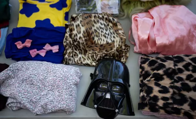 Halloween costumes and accessories are displayed during a Halloween costume swap at Occidental College in Los Angeles, Friday, Oct. 16, 2026. (AP Photo/Jae C. Hong)