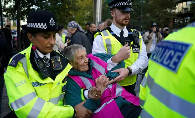Police officers arrest a protester during a demonstration in support of Palestine Action, outside the US embassy, in London, Saturday, Oct. 31, 2026. (AP Photo/Alberto Pezzali)