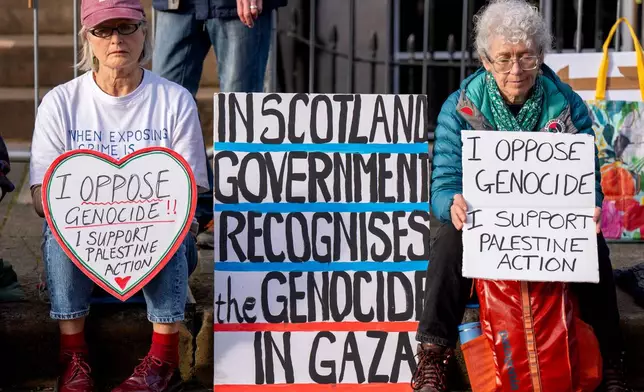 People take part in a protest outside the U.S. Consulate in support of Palestine Action ahead of a U.K. Supreme Court hearing over the group's proscription in Edinburgh, Scotland, Saturday, Oct. 31, 2026. (Jane Barlow/PA via AP)