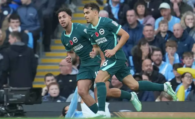 Brighton's Charalampos Kostoulas, left, and Yasin Ayar react after first goal during the English Premier League soccer match between Manchester City and Brighton & Hove Albion in Manchester, England, Saturday, Oct. 31, 2026. (AP Photo/Jon Super)