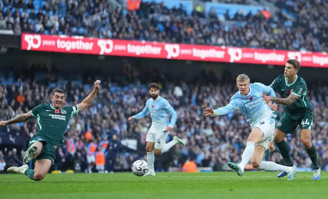 Manchester City's Erling Haaland shoots in front pf Brighton's Luka Vuskovic during the English Premier League soccer match between Manchester City and Brighton & Hove Albion in Manchester, England, Saturday, Oct. 31, 2026. (AP Photo/Jon Super)