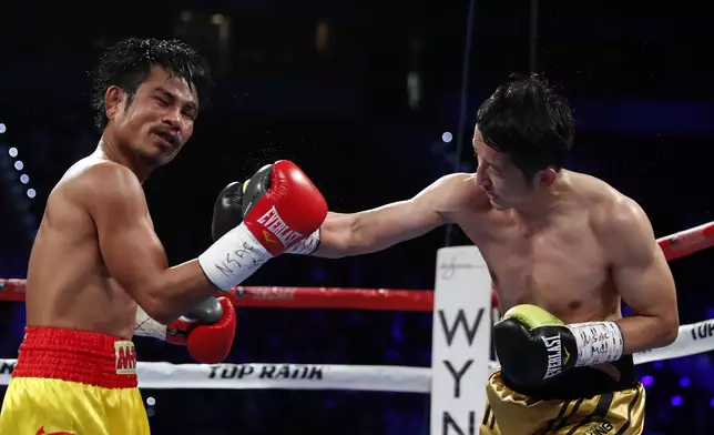 Zou Shiming, right, of China, punches Prasitak Phaprom, of Thailand, during their WBO flyweight title boxing match on Saturday, Nov. 5, 2016, in Las Vegas. Zou won by unanimous decision. (AP Photo/Isaac Brekken)