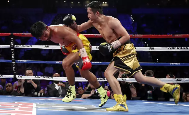 Zou Shiming, right, of China, punches Prasitak Phaprom, of Thailand, during their WBO flyweight title boxing match Saturday, Nov. 5, 2016, in Las Vegas. Zou won by unanimous decision. (AP Photo/Isaac Brekken)