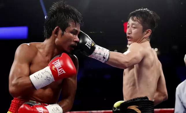 Zou Shiming, of China, right punches Prasitak Phaprom, of Thailand, during their WBO flyweight title boxing match on Saturday, Nov. 5, 2016, in Las Vegas. Zou won by unanimous decision. (AP Photo/Isaac Brekken)