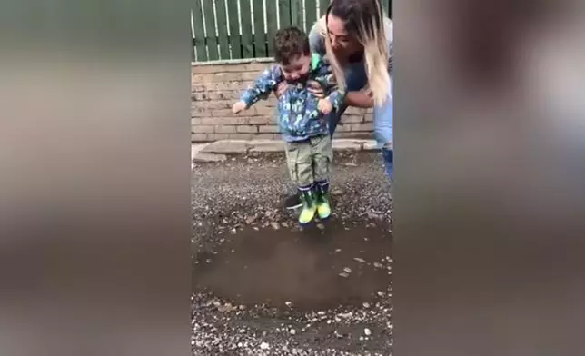 在媽媽協助下，威爾森邊踩水邊展現天真笑容。（網上圖片）